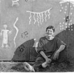 Marybeth Webster with newly completed garage door mural, May 2002